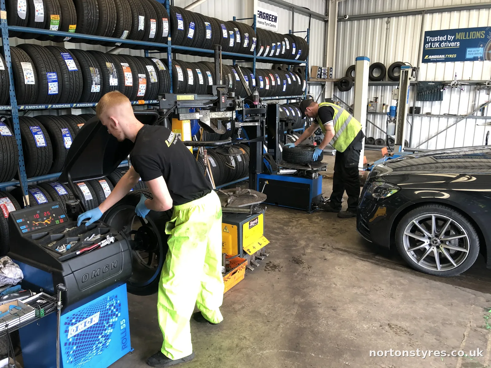 Fitters balancing car wheels in the Nortons Tyres car bay Fitters balancing car wheels in the Nortons Tyres car bay