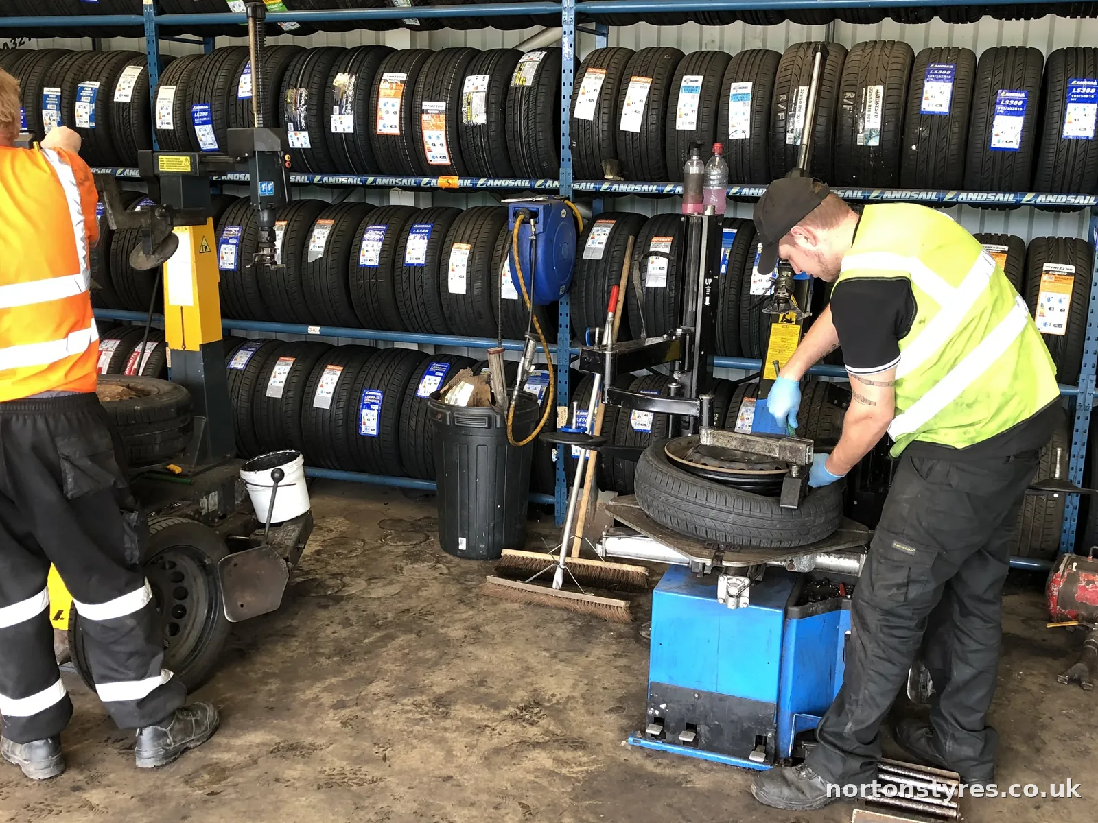 Car tyre being removed from the wheel on the tyre changer, close view Car tyre being removed from the wheel on the tyre changer, close view