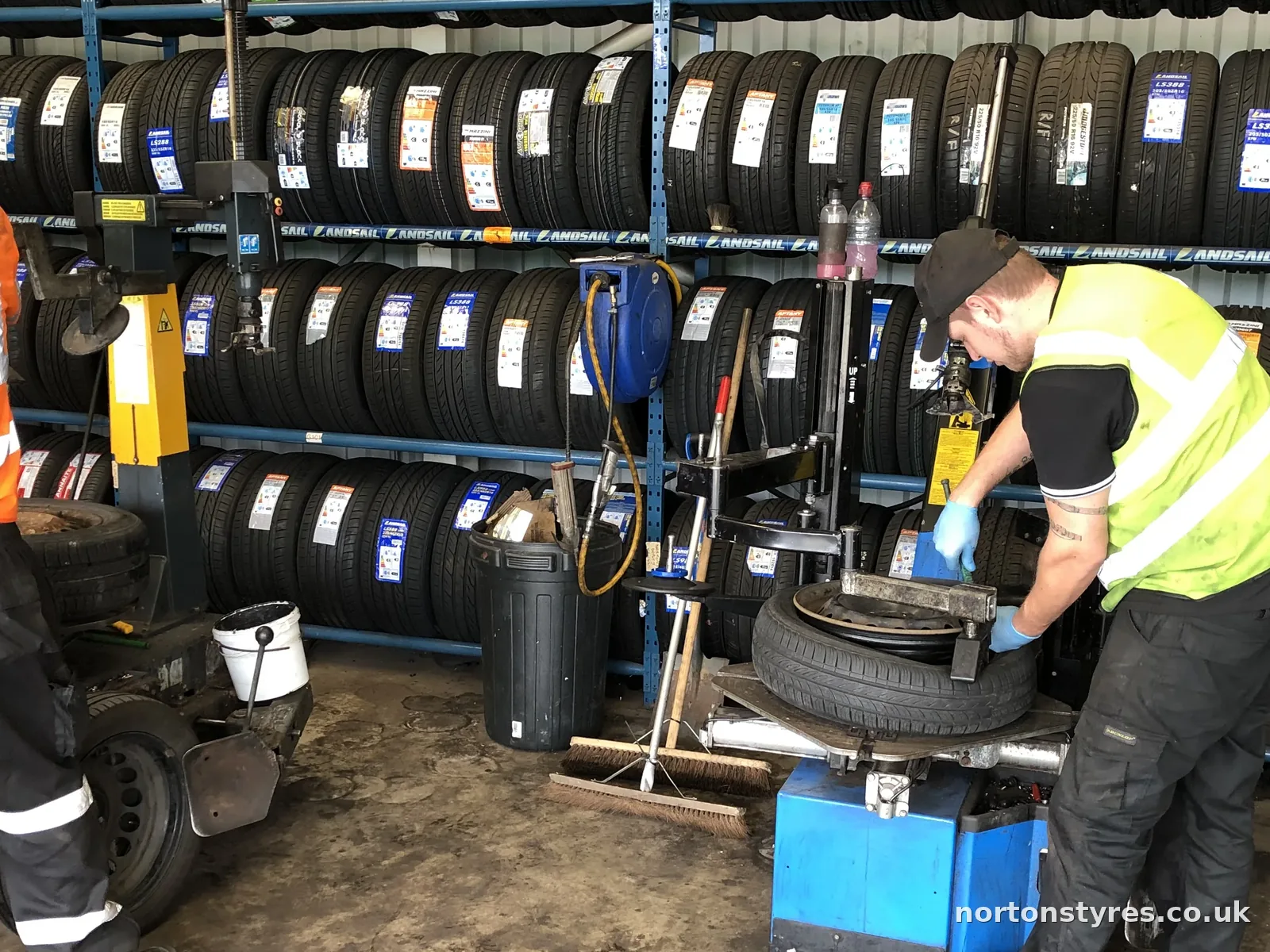 Car tyre being removed from the wheel on the tyre changer, detail Car tyre being removed from the wheel on the tyre changer, detail