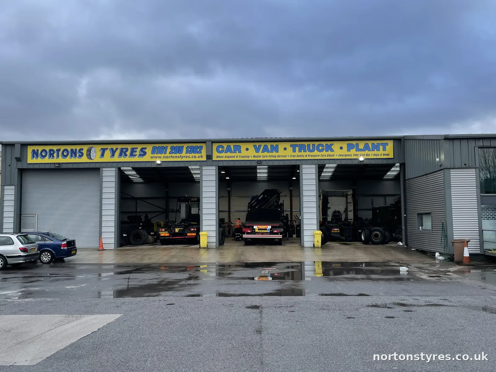 Front of the Nortons Tyres building with the bay doors open, close view