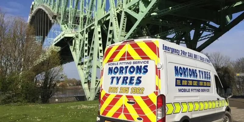 Nortons mobile fitting van parked by a river bridge Nortons mobile fitting van parked by a river bridge