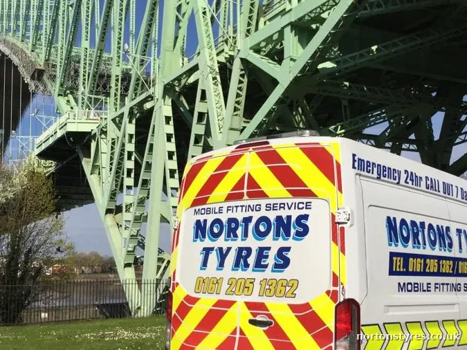 Nortons Tyres mobile fitting van parked by a river bridge, detail Nortons Tyres mobile fitting van parked by a river bridge, detail