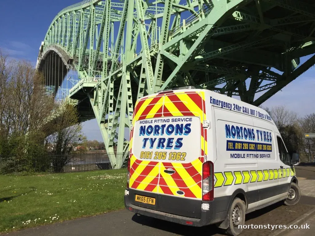 Nortons Tyres mobile fitting van parked by a river bridge Nortons Tyres mobile fitting van parked by a river bridge