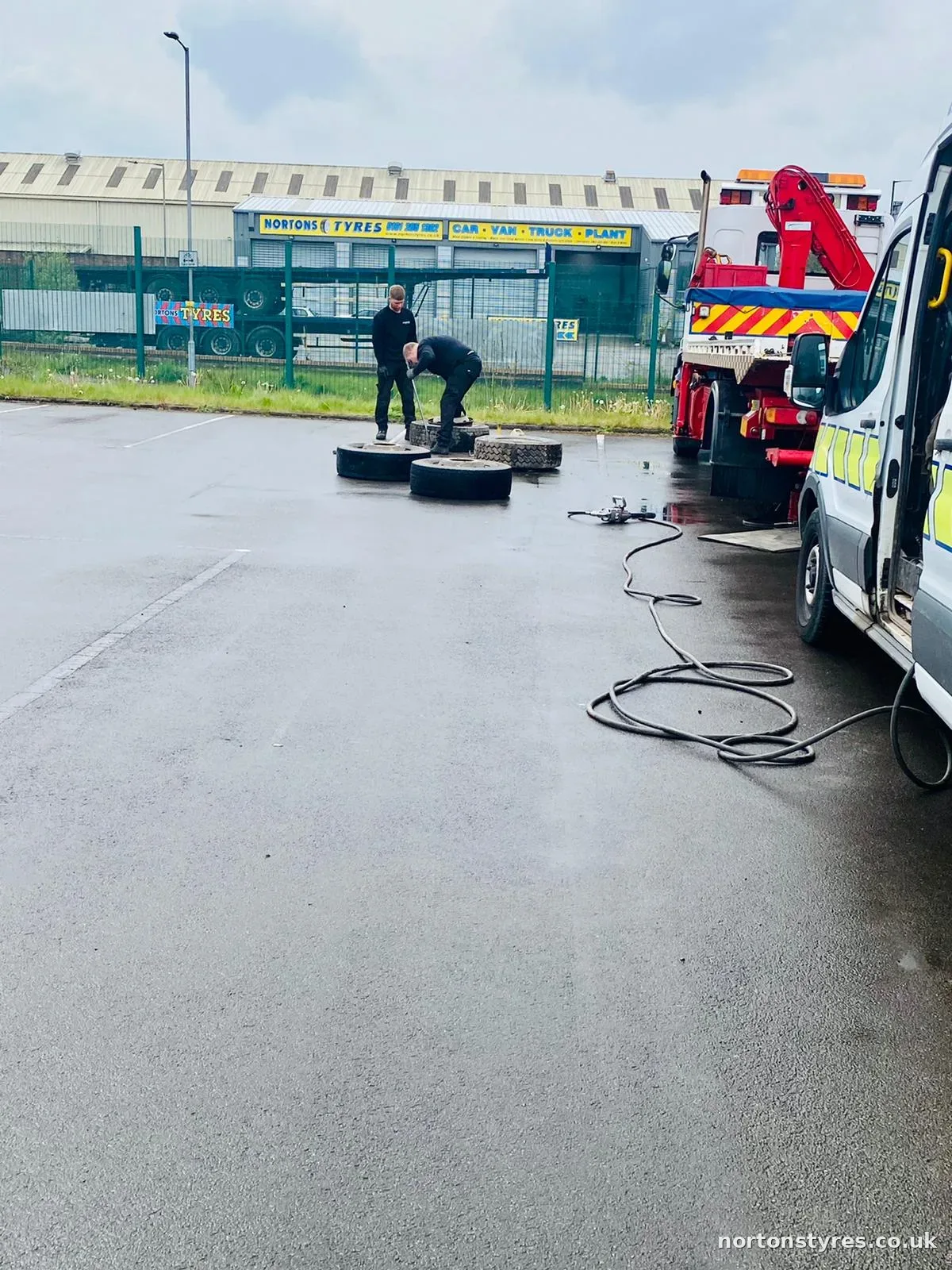 Fitters changing truck tyres in the yard Fitters changing truck tyres in the yard