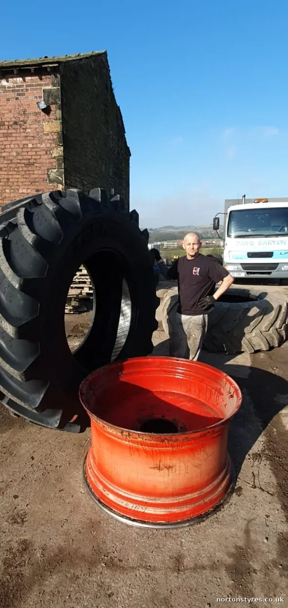 Large agricultural tyre and wheel rim on a farm, close view Large agricultural tyre and wheel rim on a farm, close view