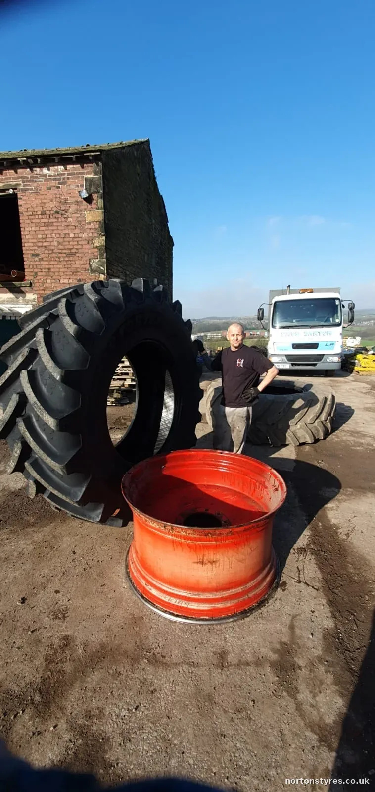 Large agricultural tyre and wheel rim on a farm Large agricultural tyre and wheel rim on a farm