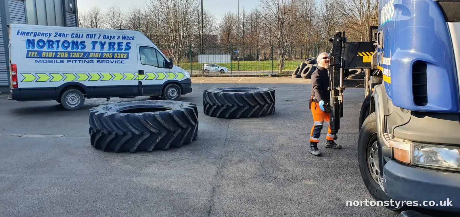 Fitter with large tractor tyres beside the Nortons Tyres van Fitter with large tractor tyres beside the Nortons Tyres van