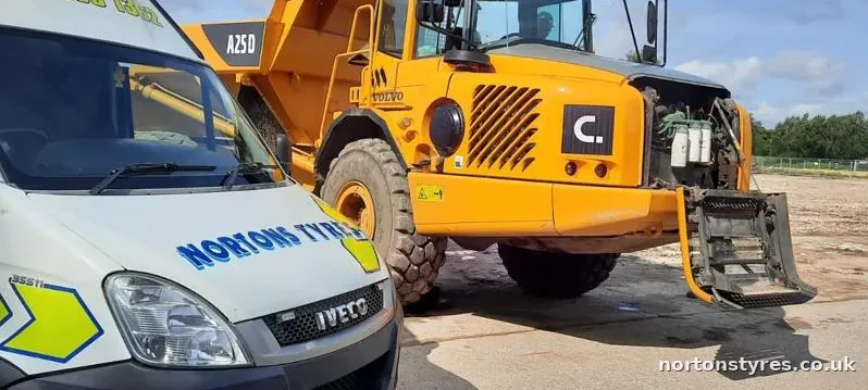 Nortons Tyres van attending an articulated dumper, close view Nortons Tyres van attending an articulated dumper, close view