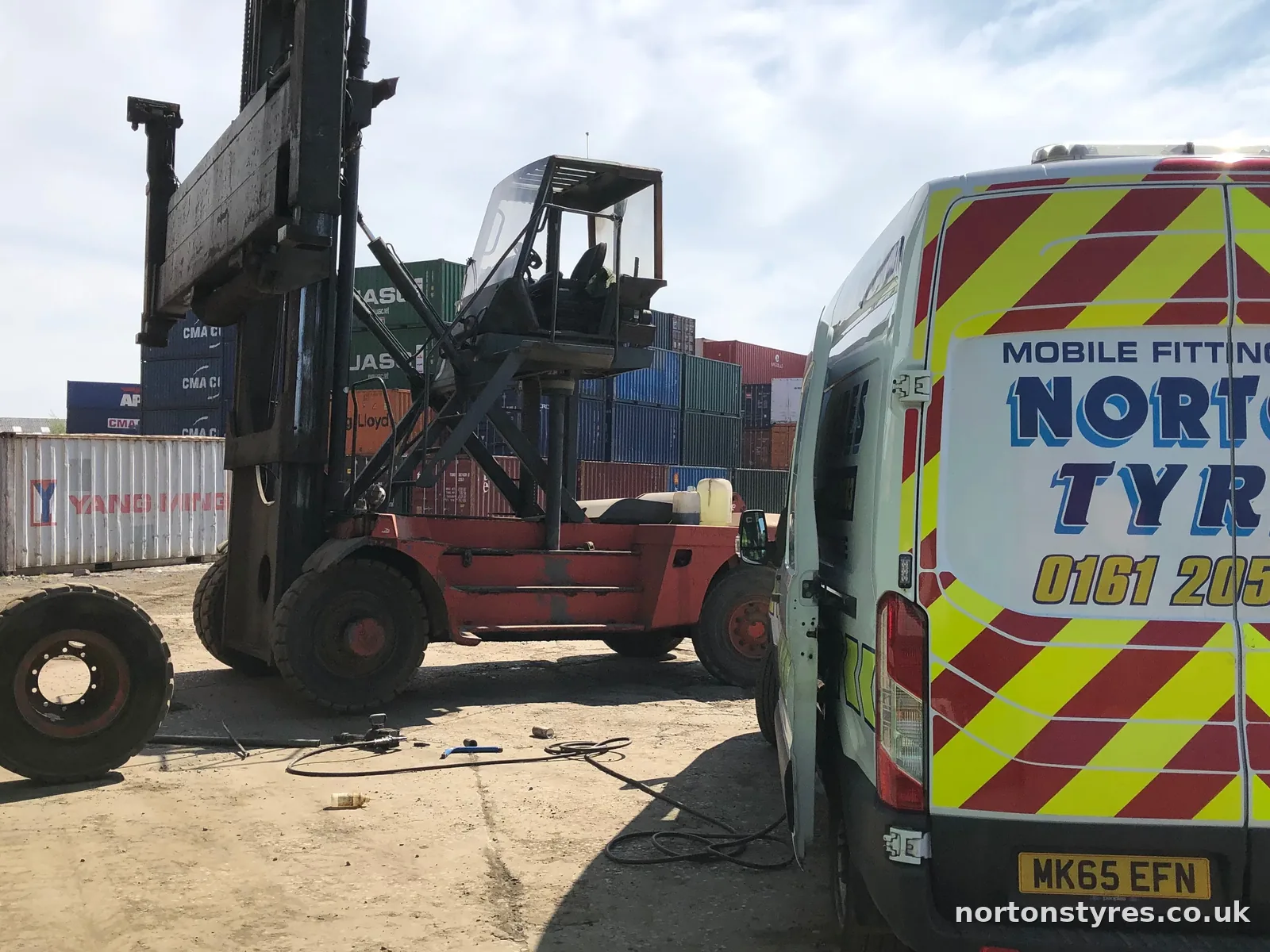 Nortons Tyres van attending a forklift in a container yard, close view Nortons Tyres van attending a forklift in a container yard, close view
