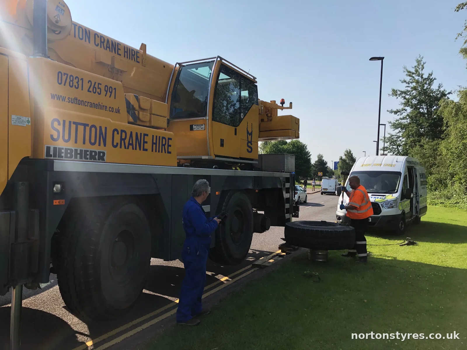 Fitters changing a tyre on a mobile crane with the Nortons van behind Fitters changing a tyre on a mobile crane with the Nortons van behind