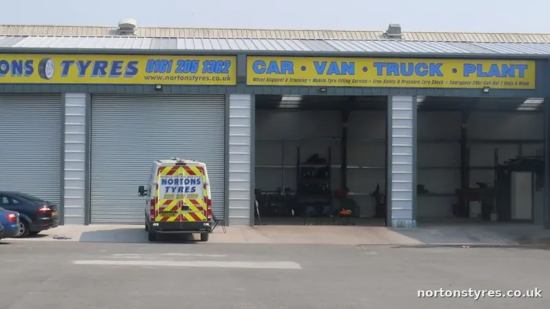 Nortons Tyres bays with a mobile van parked outside, close view Nortons Tyres bays with a mobile van parked outside, close view