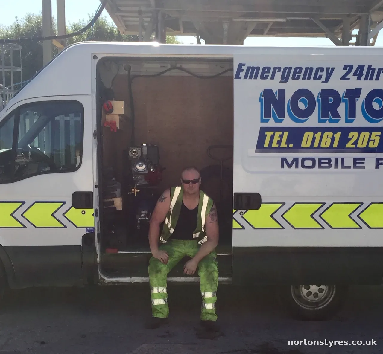 Colin Dempster sitting in the back of a Nortons Tyres mobile van