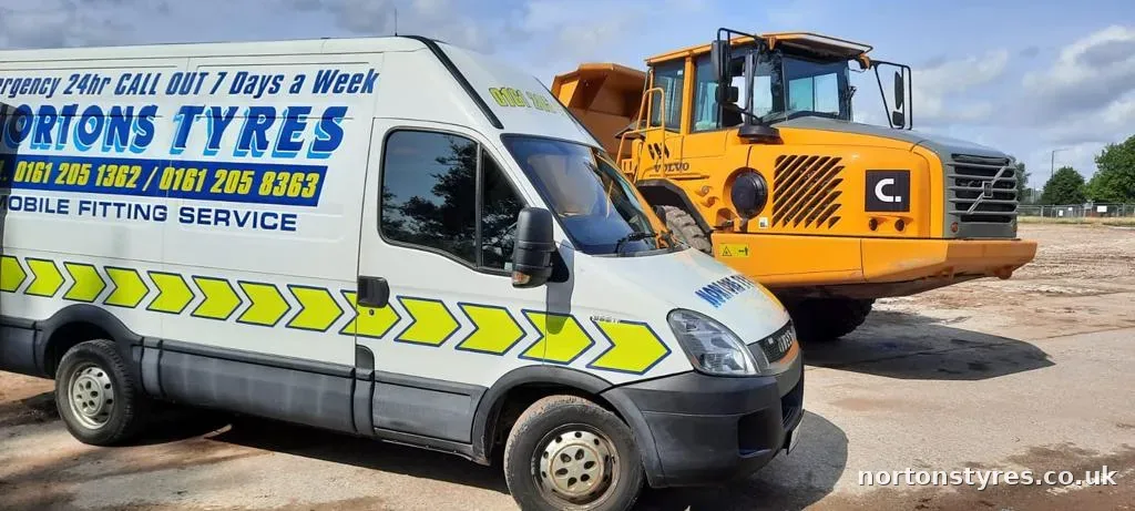 Nortons Tyres van next to an articulated dumper on site Nortons Tyres van next to an articulated dumper on site
