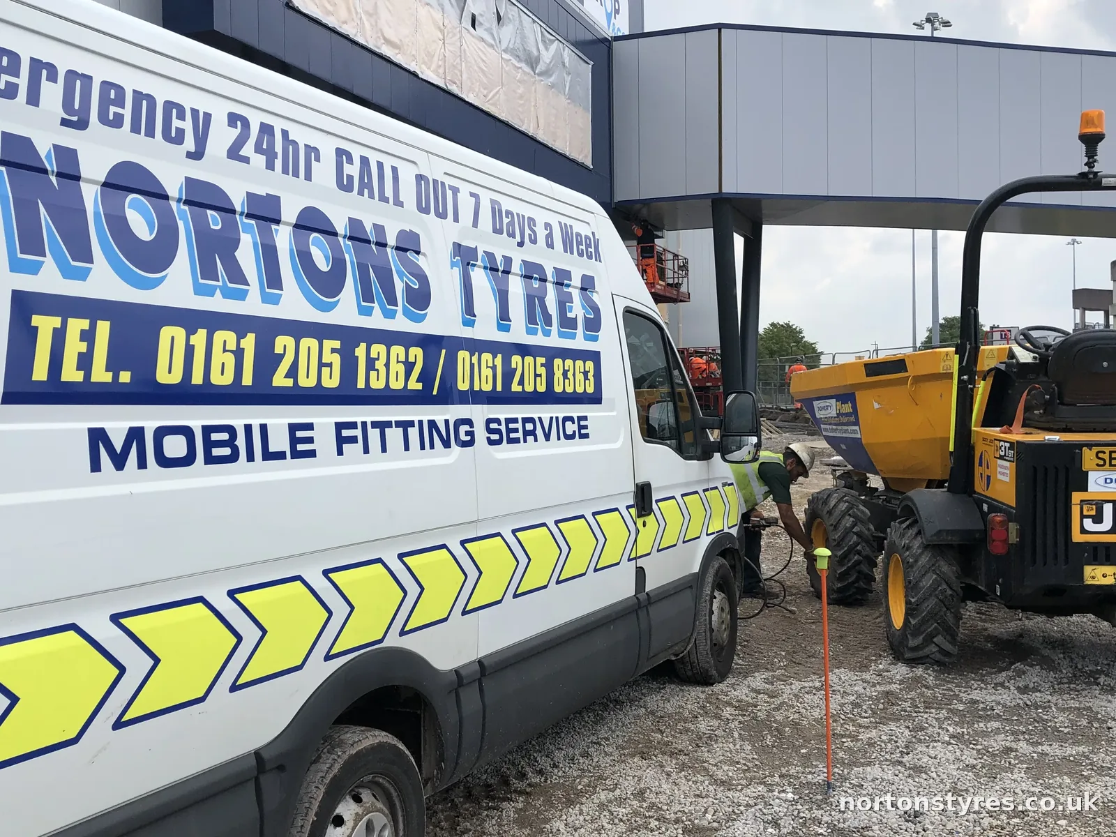 Nortons Tyres van on site beside a JCB dumper, close view Nortons Tyres van on site beside a JCB dumper, close view