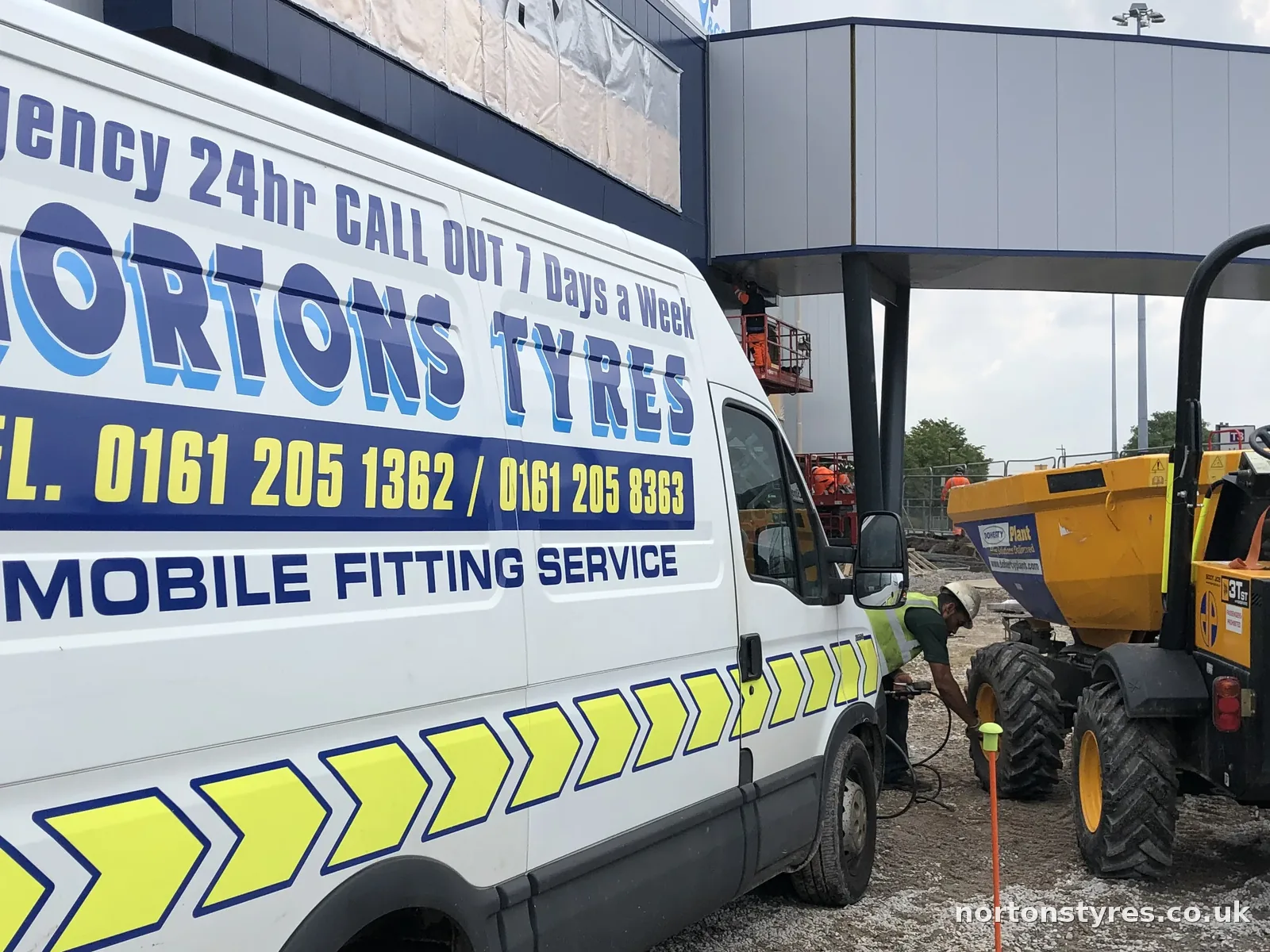 Nortons Tyres van on site beside a JCB dumper, detail Nortons Tyres van on site beside a JCB dumper, detail
