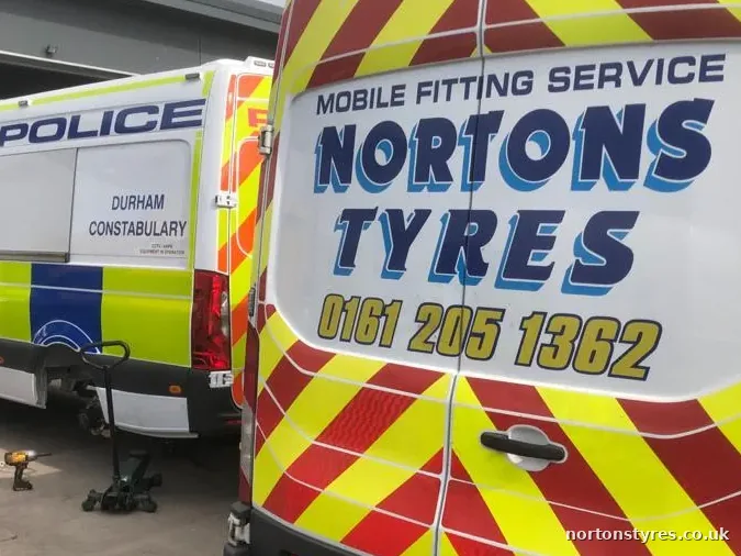 Nortons Tyres van alongside a police van, detail Nortons Tyres van alongside a police van, detail