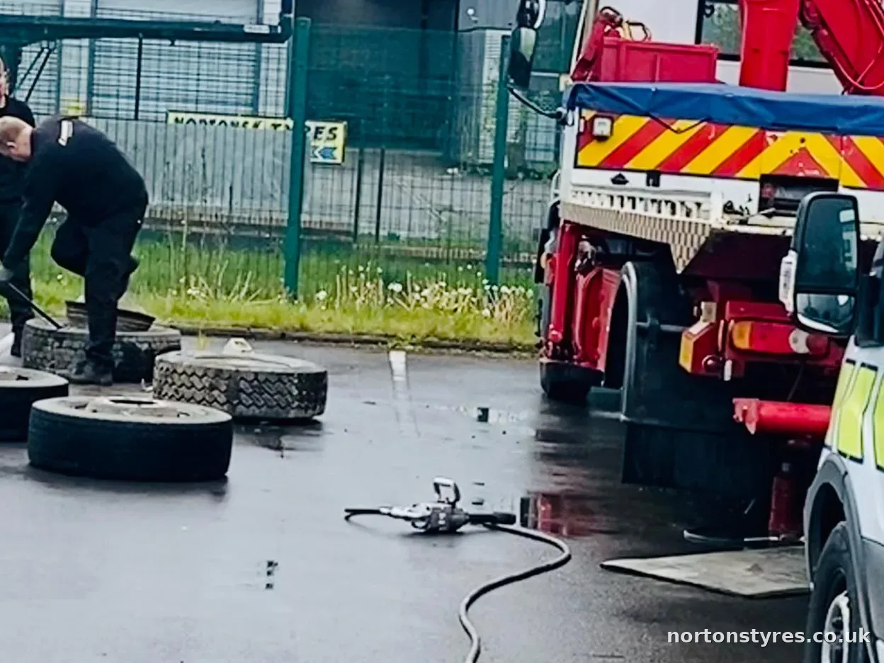 Fitters changing truck tyres beside a recovery truck, close view Fitters changing truck tyres beside a recovery truck, close view