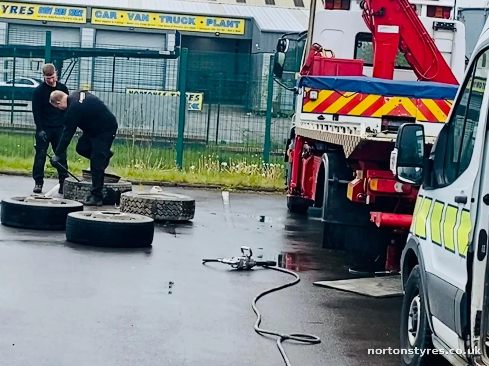 Fitters changing truck tyres beside a recovery truck Fitters changing truck tyres beside a recovery truck