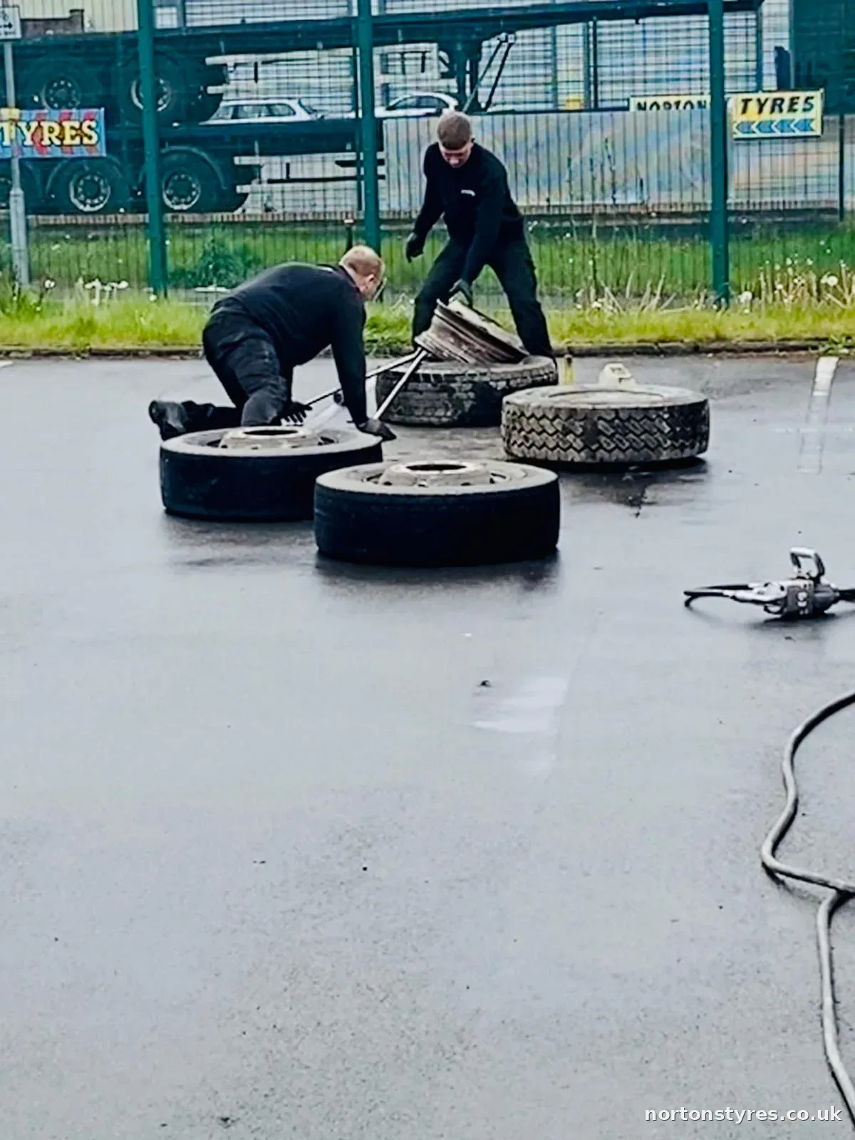Fitters with truck wheels laid out in the yard Fitters with truck wheels laid out in the yard