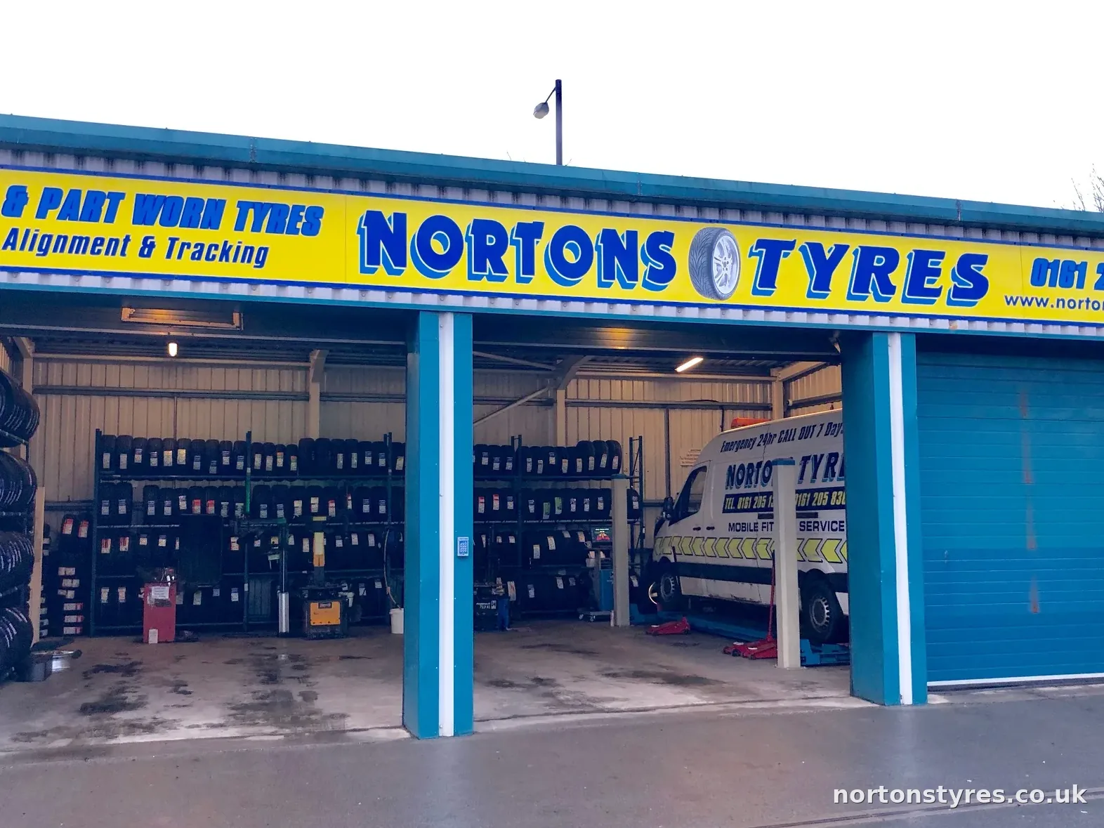 Nortons Tyres car bay with tyre racks inside, close view Nortons Tyres car bay with tyre racks inside, close view