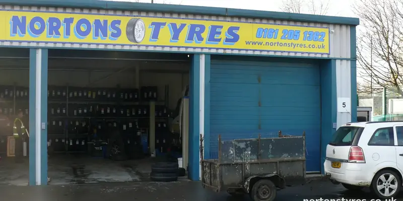 Nortons Tyres bays and sign, close view Nortons Tyres bays and sign, close view