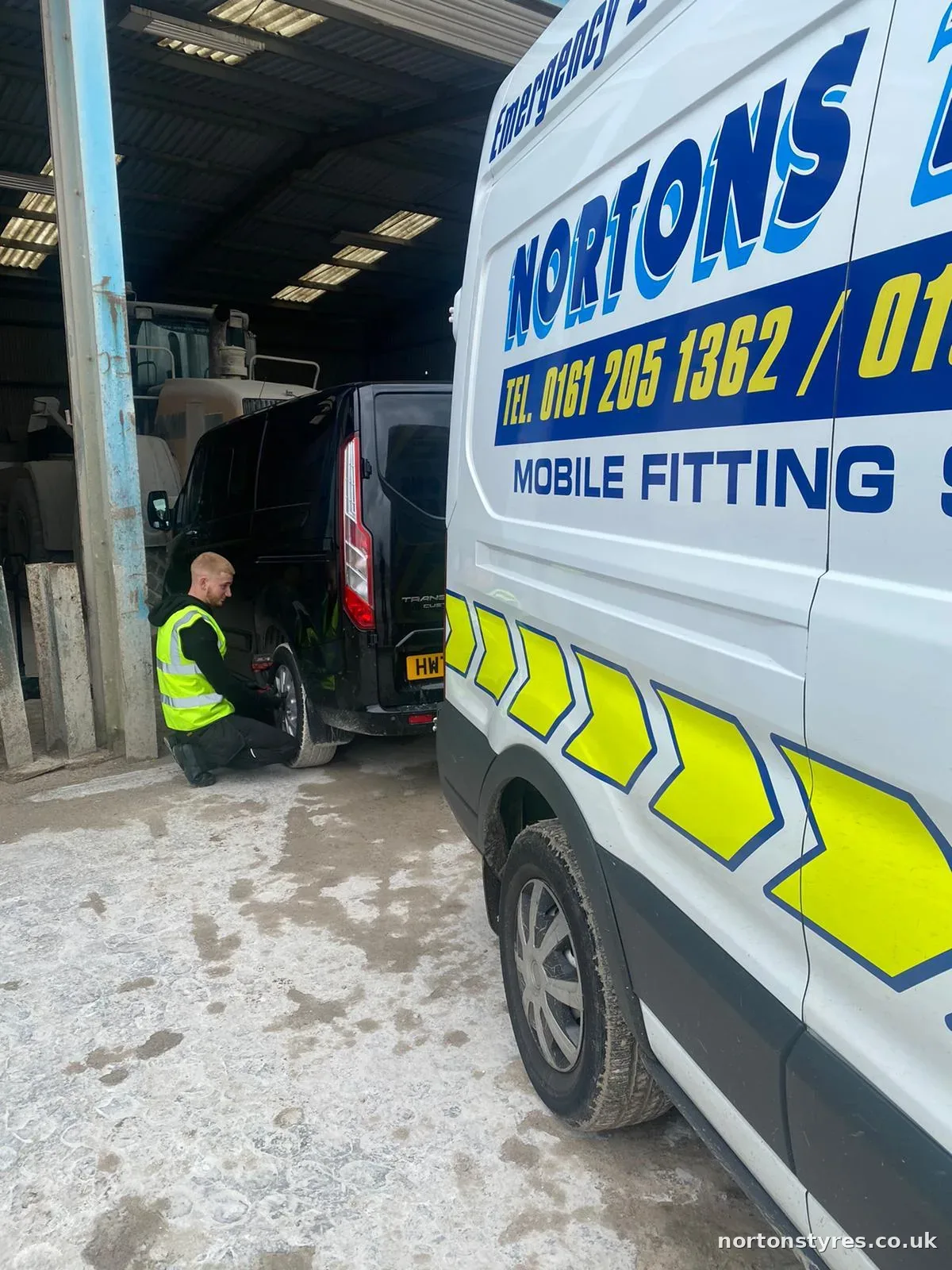 Fitter beside the Nortons van on a call-out in Accrington Fitter beside the Nortons van on a call-out in Accrington
