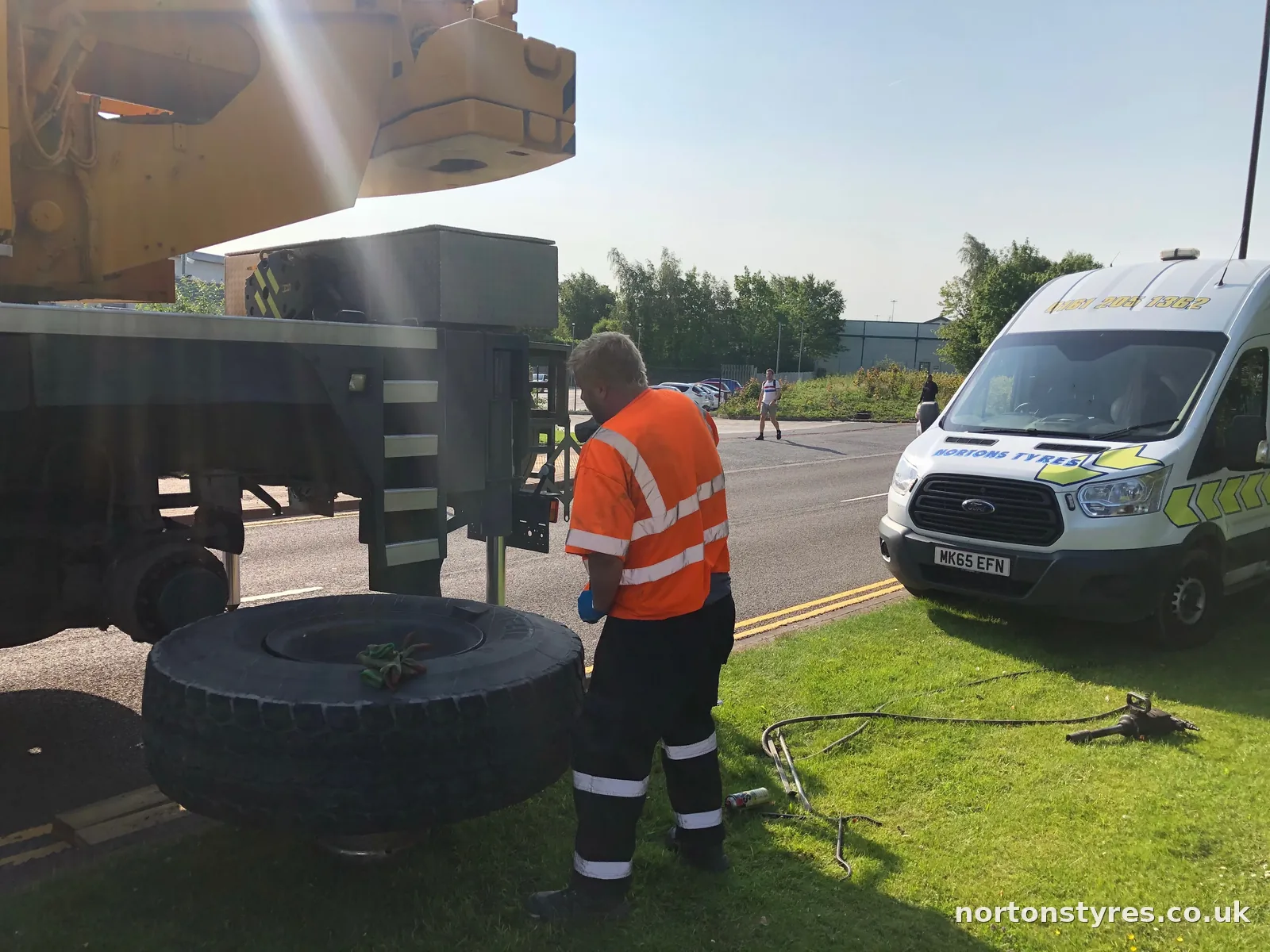 Fitter changing a lorry tyre with the Nortons van behind Fitter changing a lorry tyre with the Nortons van behind