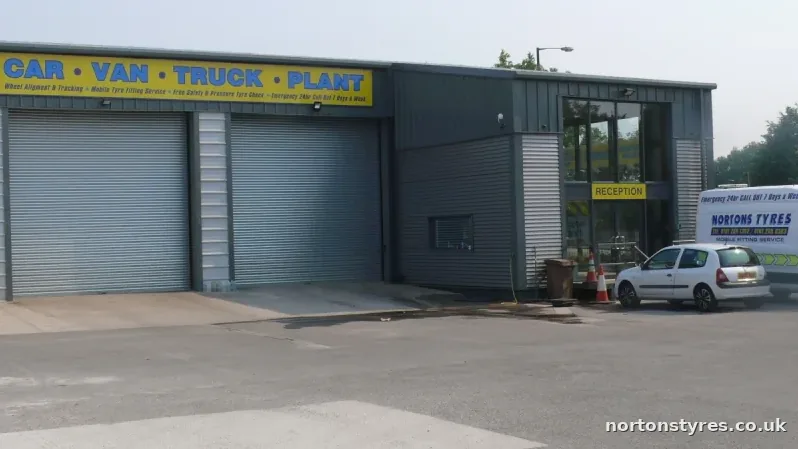 Nortons Tyres bays with a mobile van parked outside, close view Nortons Tyres bays with a mobile van parked outside, close view