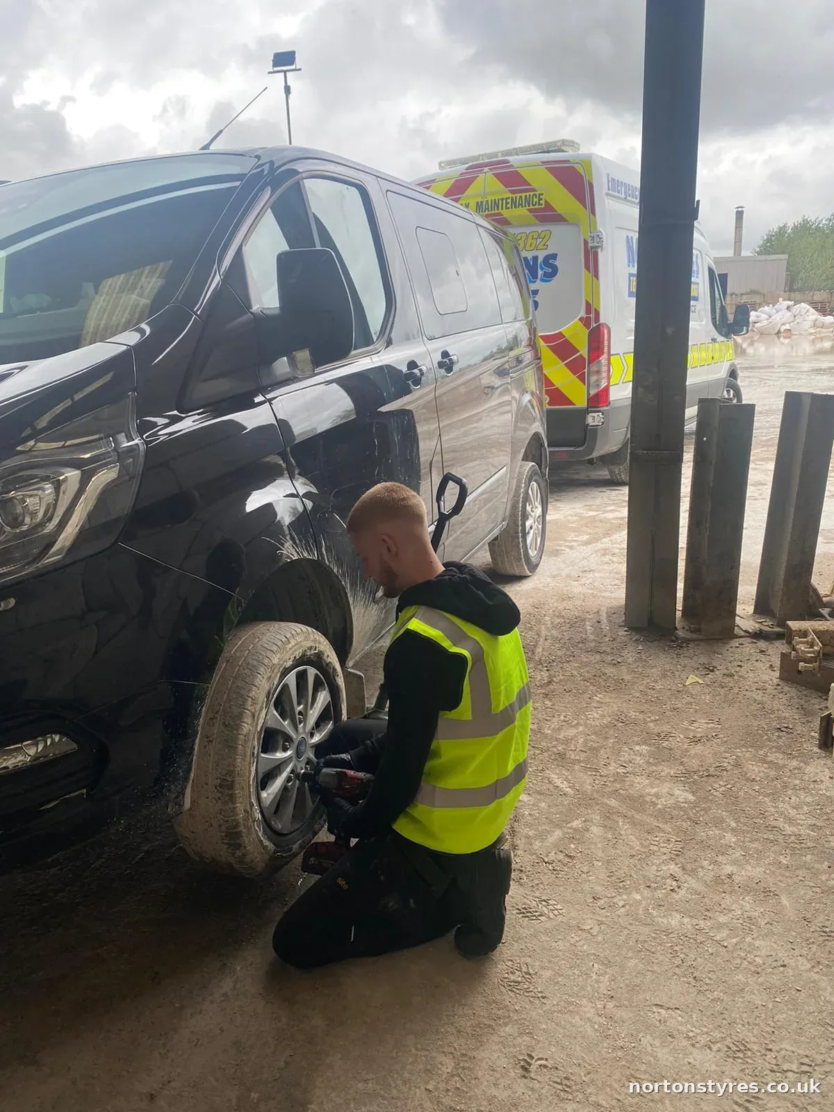Fitter changing a car tyre on a call-out in Accrington Fitter changing a car tyre on a call-out in Accrington