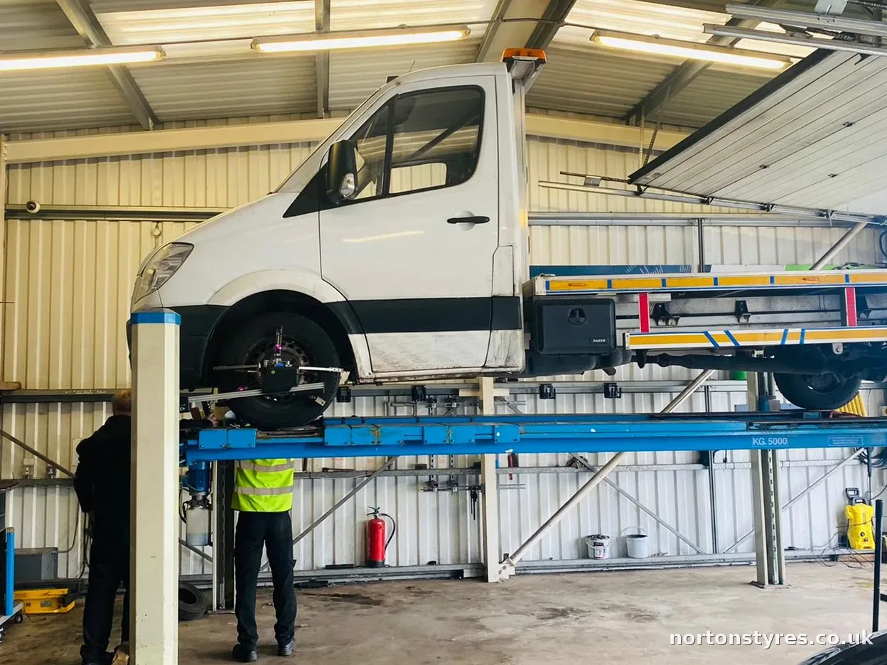 Van on the wheel alignment ramp, close view Van on the wheel alignment ramp, close view