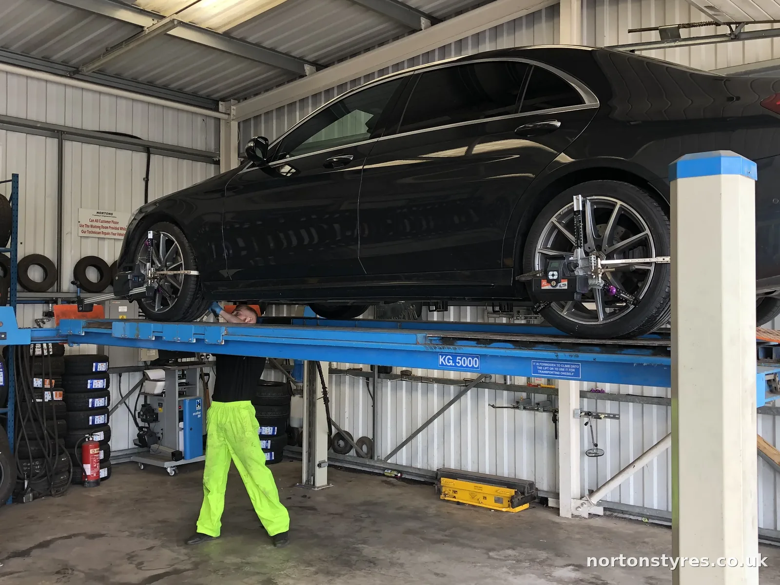 Car raised on the wheel alignment ramp, close view Car raised on the wheel alignment ramp, close view
