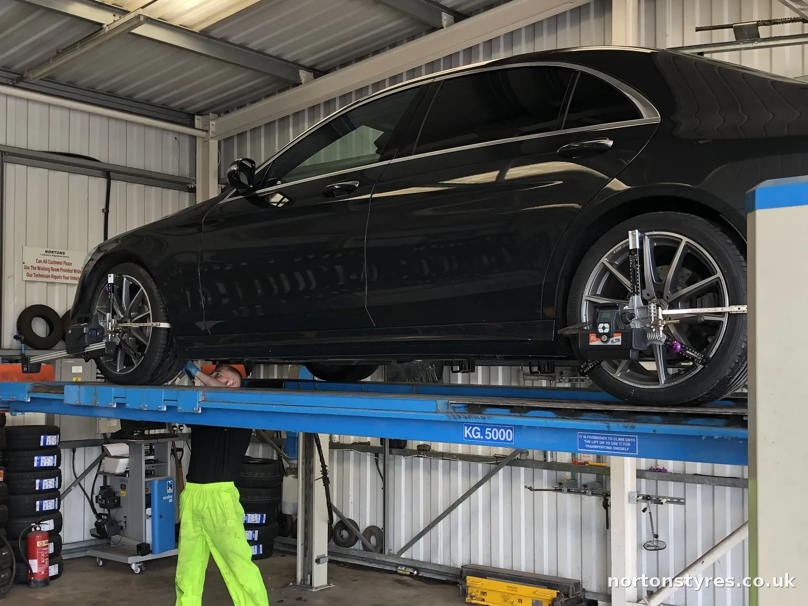 Car raised on the wheel alignment ramp, detail Car raised on the wheel alignment ramp, detail