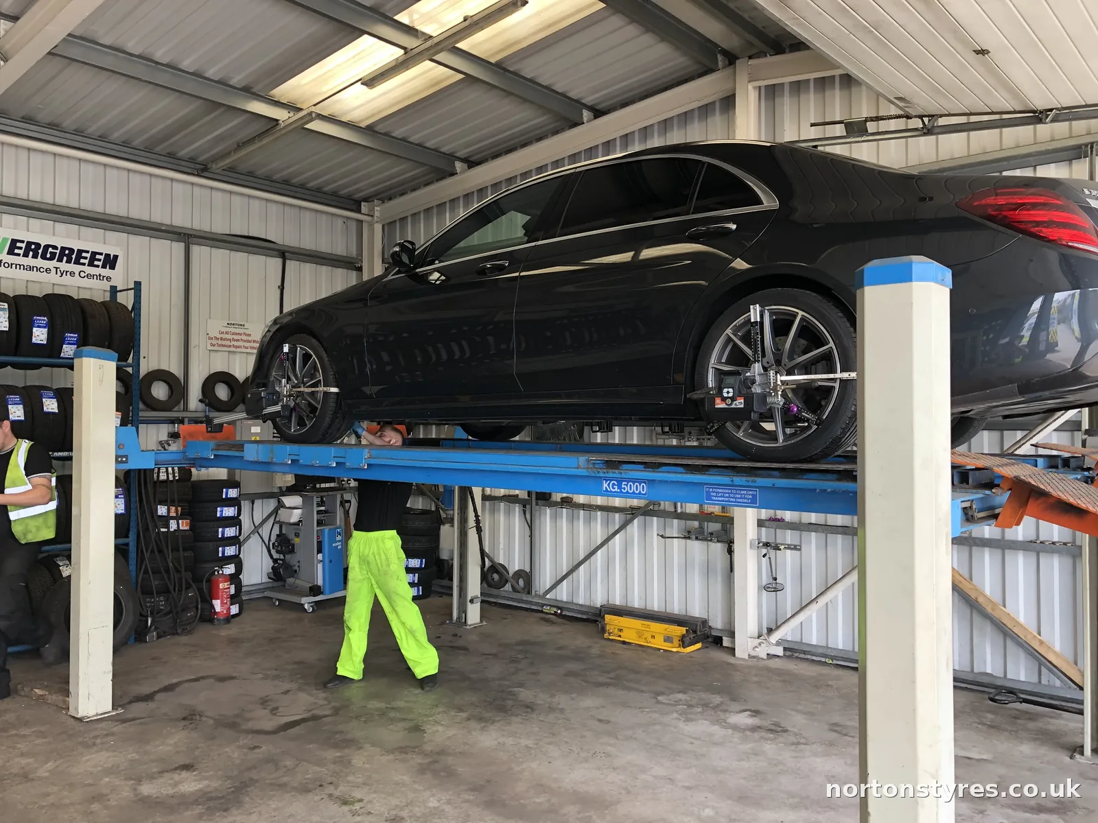Car raised on the wheel alignment ramp Car raised on the wheel alignment ramp